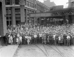 A large crowd poses for a photograph beside the Elevated around 1930, at the intersection of Harrison Avenue and Beach Street. The building at left is the Kingston Clothing Company. The event memorialized in the photo is unknown. (Photograph by Leslie Jones, courtesy of the Boston Public Library.)